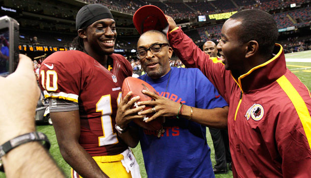 Washington Redskins quarterback Robert Griffin III (10) poses for a photo with filmmaker Spike Lee, c, after an NFL football game against the New Orleans Saints in New Orleans, Sunday, Sept. 9, 2012. The Redskins won 40-32. /AP Photo/Matthew Hinton