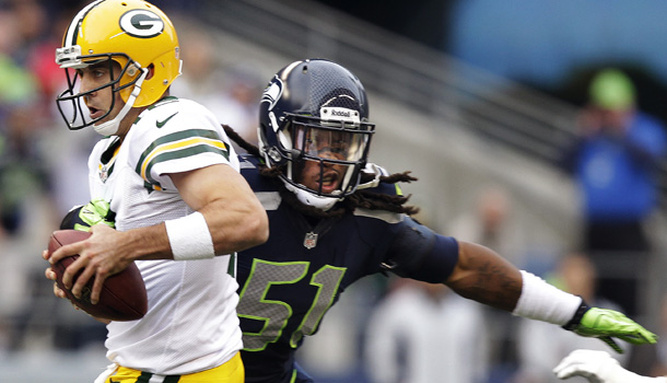 Green Bay Packers quarterback Aaron Rodgers, l, is sacked by Seattle Seahawks defensive end Bruce Irvin (51) in the first half of the controversial NFL game, Monday, Sept. 24, 2012, in Seattle. /AP Photo/Stephen Brashear