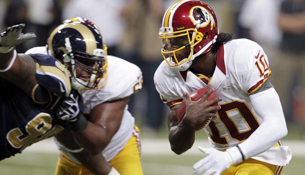 Washington Redskins quarterback Robert Griffin III (10) runs past St. Louis Rams defensive tackle Kendall Langford on his way to a touchdown run during the third quarter of an NFL football game, Sunday, Sept. 16, 2012, in St. Louis. /Photo: Tom Gannam/AP