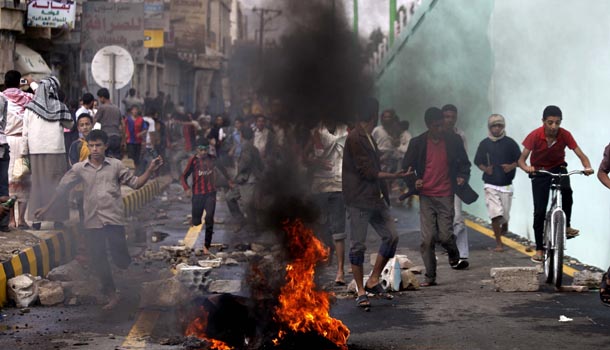 Protesters run as police, unseen, open fire into the air near the U.S. Embassy during a protest about a film ridiculing Islam's Prophet Muhammad, in Sanaa, Yemen, Thursday, Sept. 13, 2012. Yemen's president has apologized to President Barack Obama for the attack on the U.S. Embassy in Sanaa, the Yemeni capital, by a mob angry over an anti-Islam film. /AP Photo/Hani Mohammed