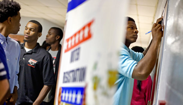 Students at Clark Atlanta University, register to vote following civil rights icon the Rev. Joseph Lowery's speech at the school's convocation Tuesday, Sept. 18, 2012, in Atlanta. Lowery urged young people to vote. /AP Photo/David Goldman