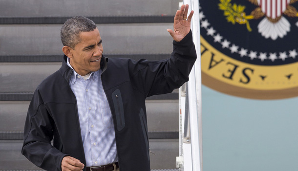 President Barack Obama waves from Air Force One as he arrives in Madison, Wis., Thursday, Oct. 4, 2012. /AP Photo/Tom Lynn