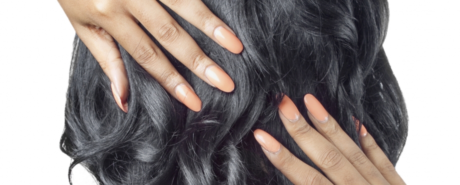 Black woman with hands on her relaxed hairstyle.