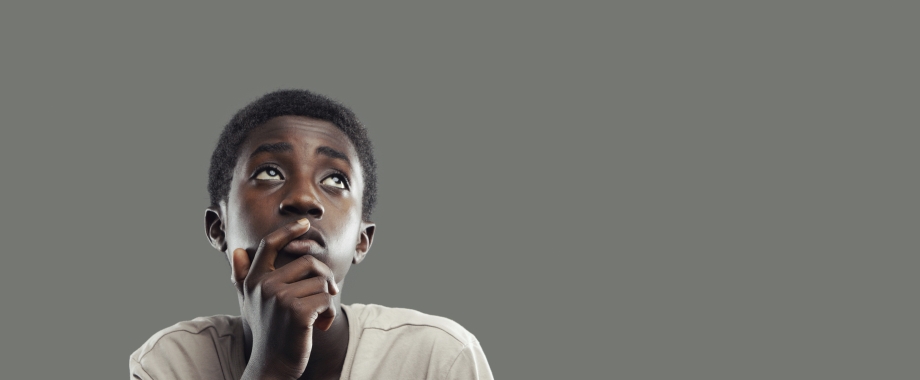 Young black male child looking skyward.