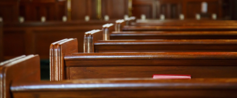 Row of empty church pews.