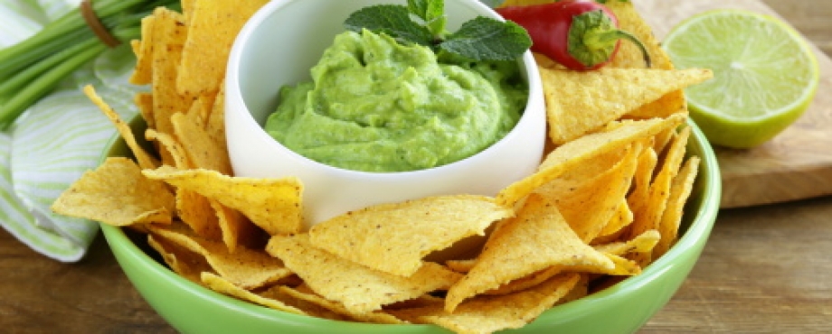 guacamole and chips with a lime